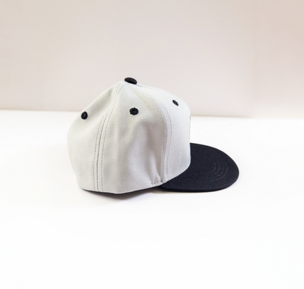 grey cap with black brim on a light beige background