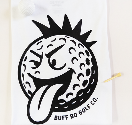 White towel with a black graphic of a golf ball with a face and 'Buff Bo Golf Co.' text on a white background
