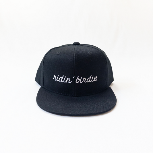 Black cap with 'ridin' birdie' text on a white background
