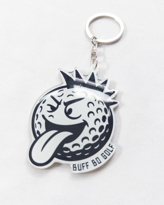 Keychain with a golf ball and crown design on a white background