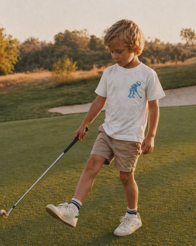 Young boy on a golf course holding a golf club