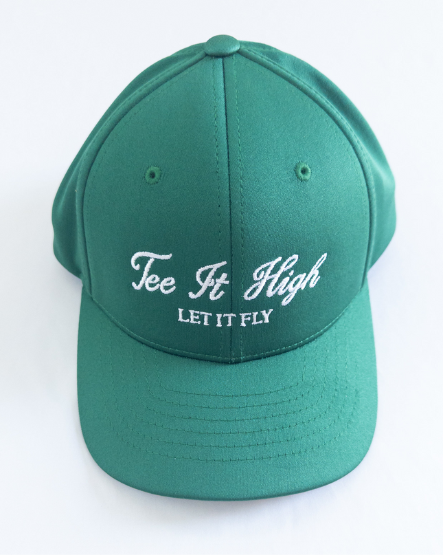 Green golf hat with white embroidered text reading 'Tee It High, Let It Fly,' classic and motivational golf headwear designed for young golfers and golf lovers, displayed on a neutral background.