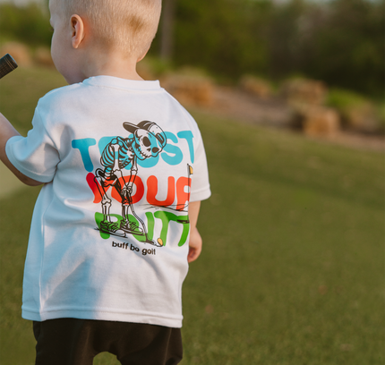Child wearing a t-shirt with a colorful graphic design outdoors