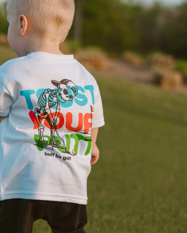 Child wearing a t-shirt with a colorful graphic design outdoors