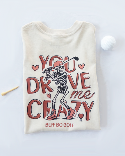 Beige t-shirt with skeleton graphic and text on a white background