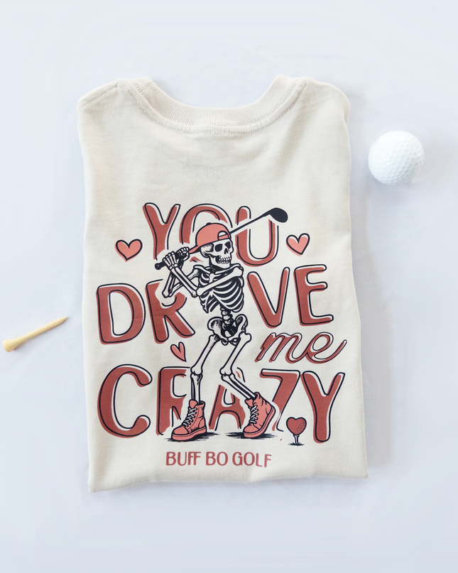 Beige t-shirt with skeleton graphic and text on a white background