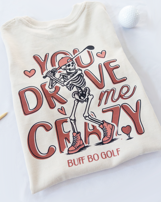 Beige t-shirt with skeleton design and text on a white background